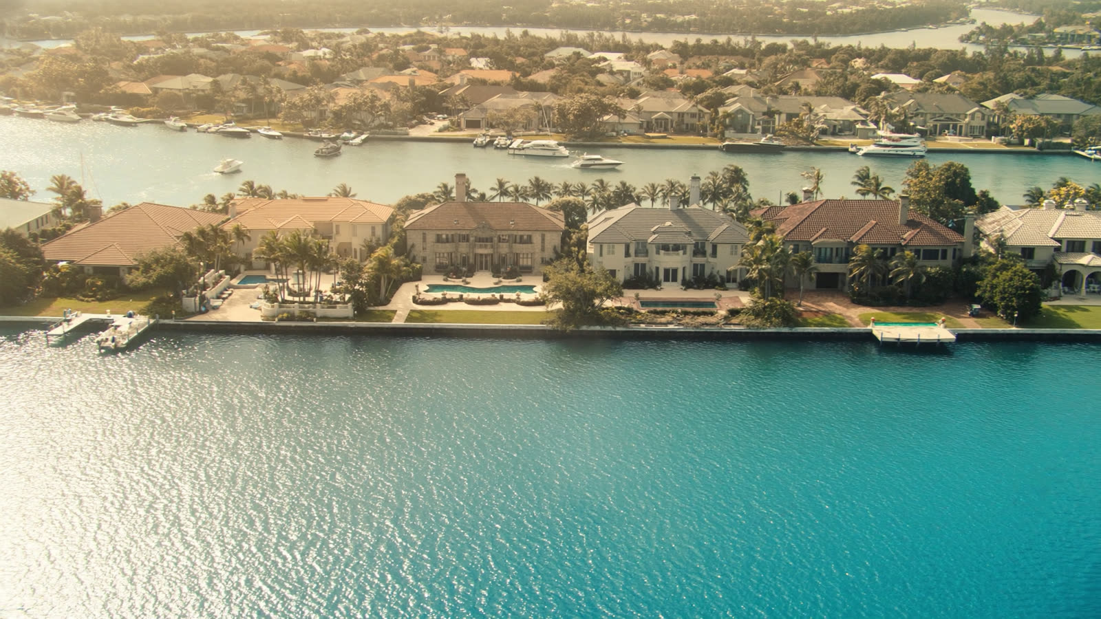 Aerial view of a Florida waterfront community with canal-front homes and docks